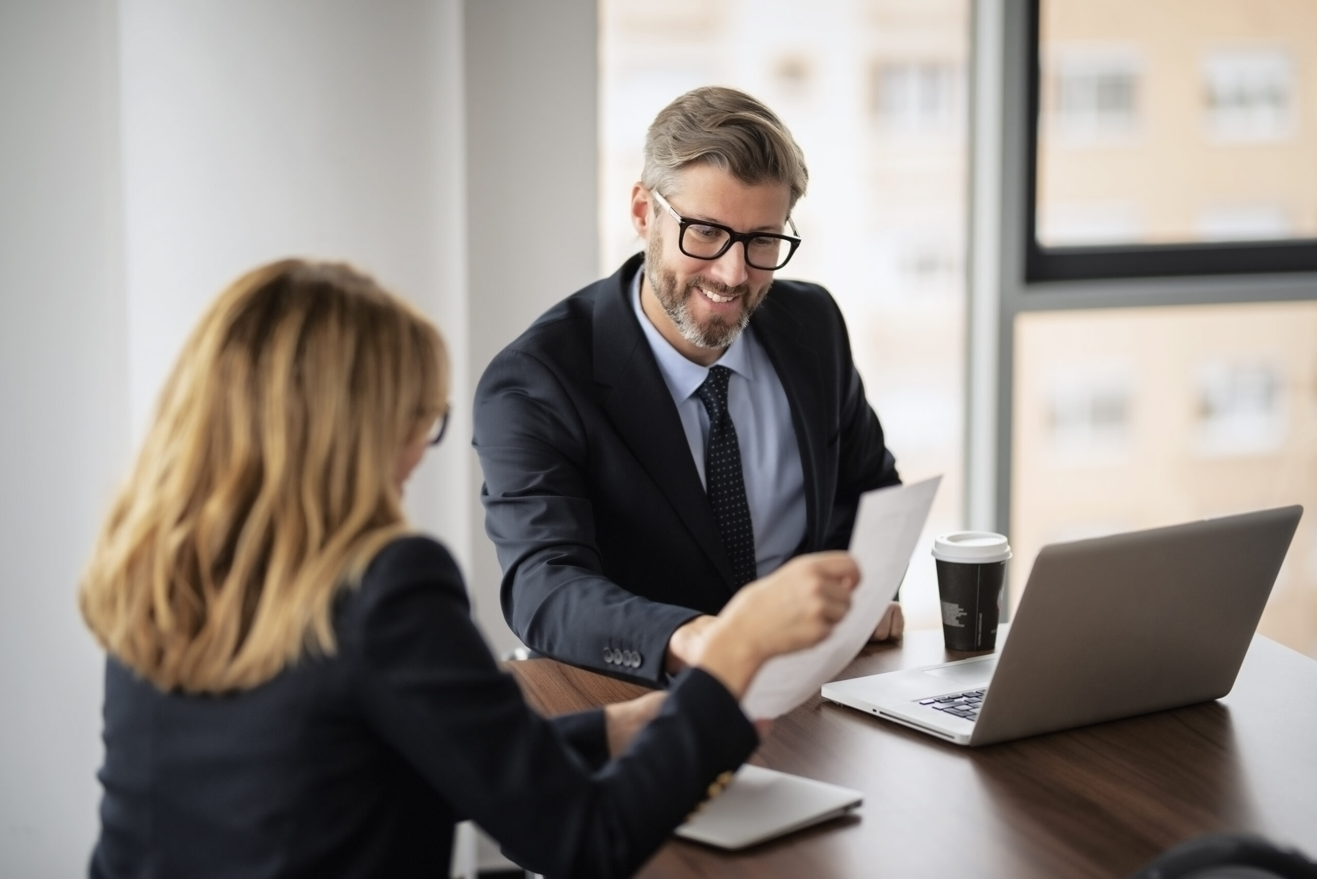 Shot of two businesspeople working on a laptop in the boardroom. Teamwork at the office.